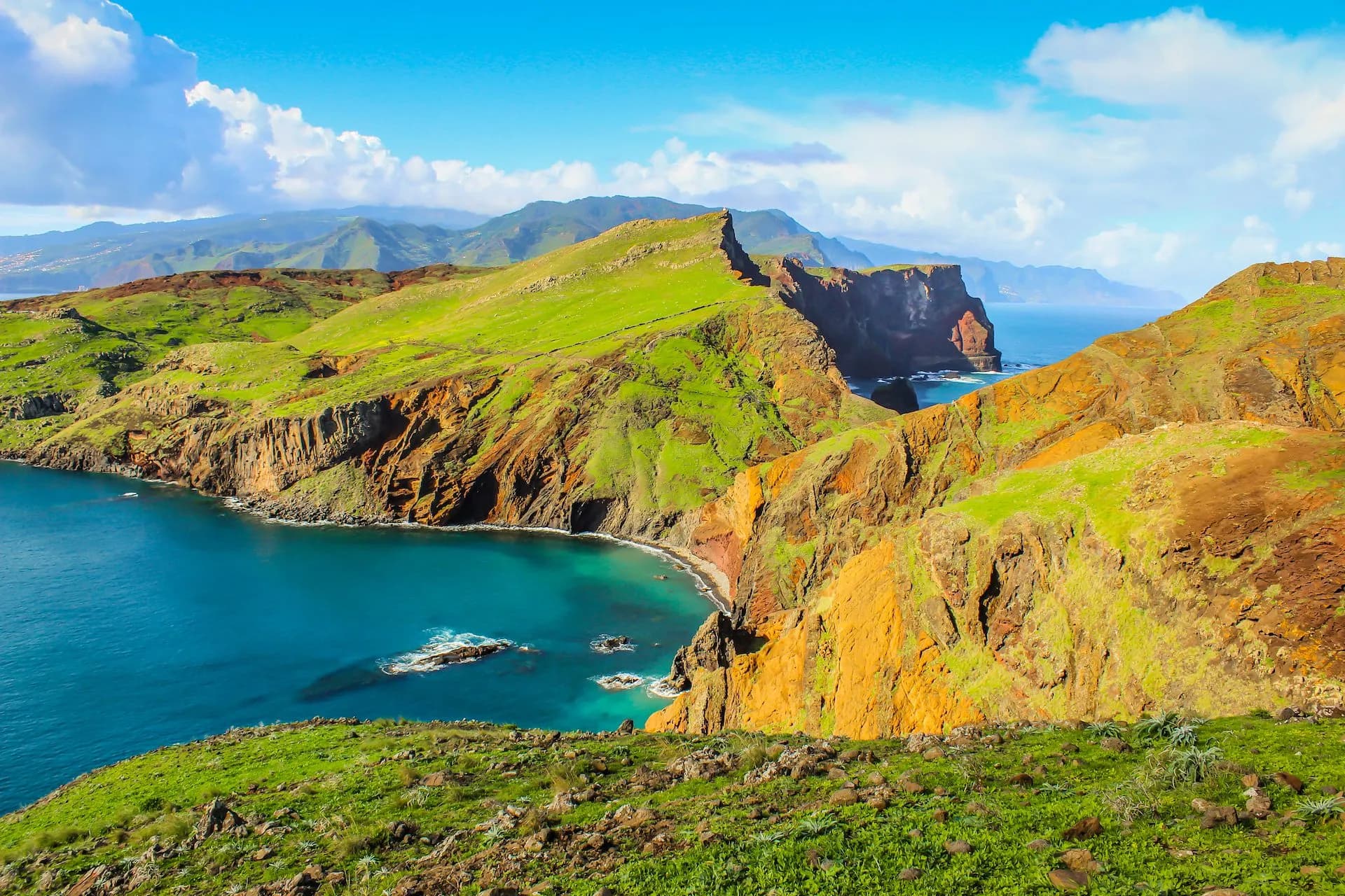 Ponta de São Lourenço dramatic cliffs and bright blue ocean under a sunny sky.